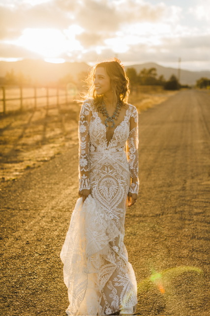 bride in white lace dress in the sunlight