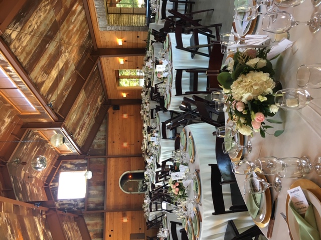 tables set up for event inside large barn