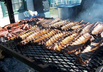 Santa Maria Ribs and Sausages cooking on the grill