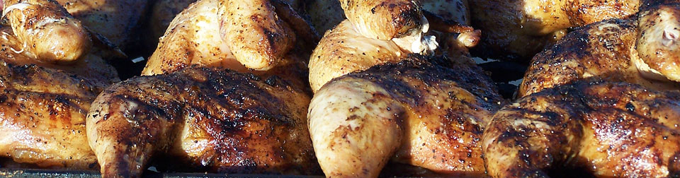 closeup of chicken cooking on a grill