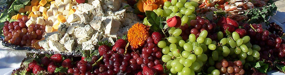 closeup display of fruits and cheeses