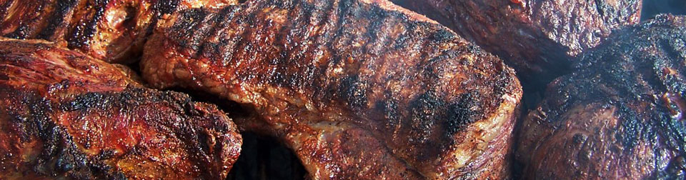 closeup of beef on cooking on a grill